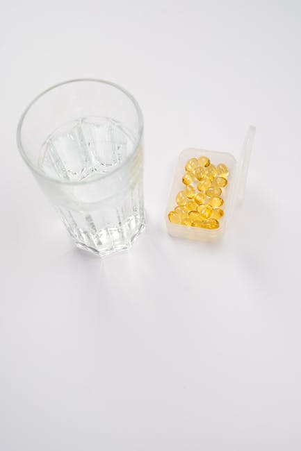 Glass of water and supplements representing daily health routine